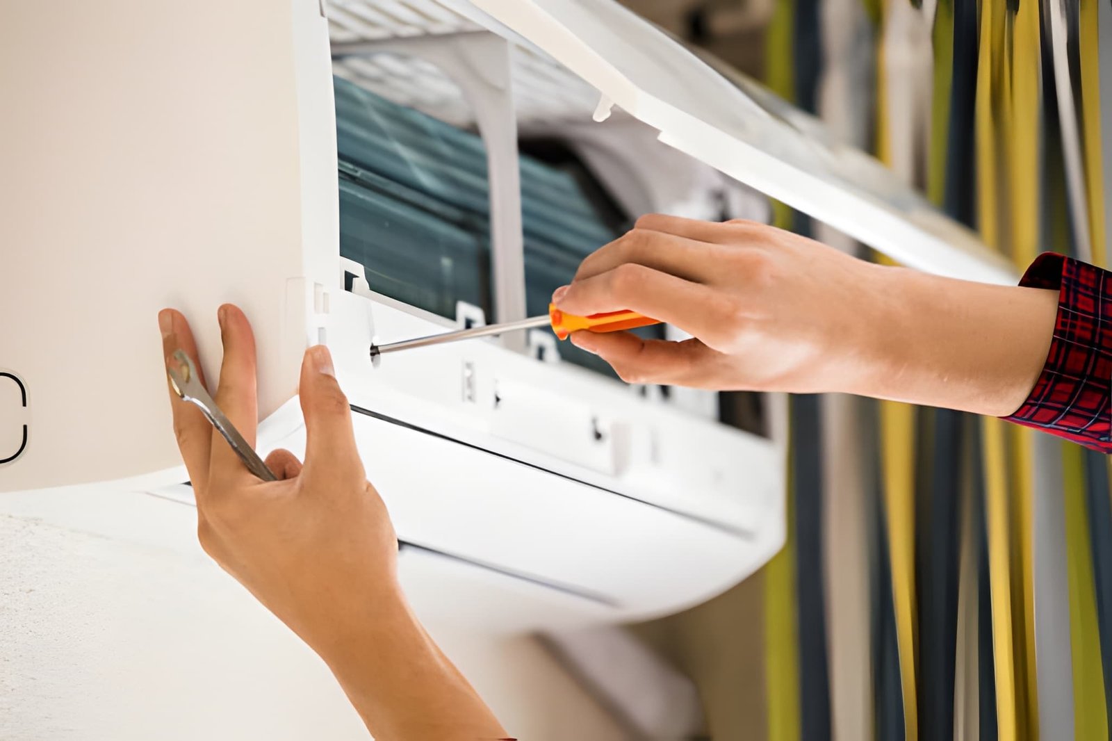 HVAC technician performing HVAC repair in Oshawa home to improve energy efficiency and reduce high electricity bills.