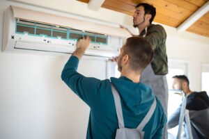 HVAC technician repairing AC unit to improve cooling and indoor air quality