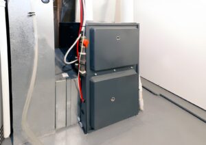 Professional furnace installation Ajax technician installing an energy-efficient home heating system.